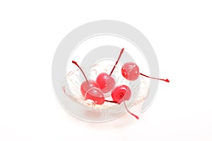 Ppreserving in syrup cherries in a glass bowl isolated on a white background.