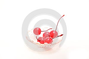 Ppreserving in syrup cherries in a glass bowl isolated on a white background