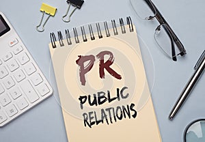 PR acronym word on paper. Public Relations concept photo