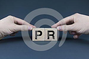 PR. Cubes form the words PR Public Relations