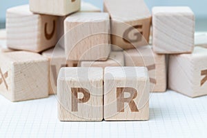 PR, Public Relations concept, wooden cube block with letters for photo