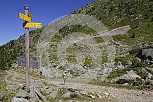 Walker and directions on mountain paths