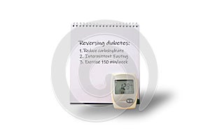 A practical spiral-bound notebook lays open, revealing three actionable tips for reversing diabetes through lifestyle changes.