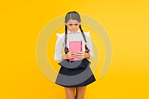 Practice and improve reading skills for school studies. Back to school concept. Girl hold book. School girl on yellow