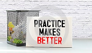Practice Makes Better text written on a notebook with pencils