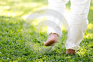 The practice of walk back and forth in the grass of men in white pants, Meditation, peaceful and refreshing