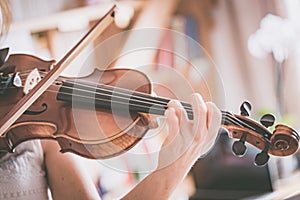 Practicing classical music and violin concept: Young girl happily plays on her new violin