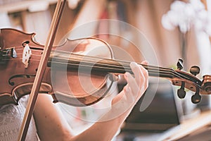 Practicing classical music and violin concept: Young girl happily plays on her new violin