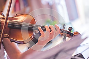 Practicing classical music and violin concept: Young girl happily plays on her new violin