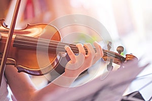 Practicing classical music and violin concept: Young girl happily plays on her new violin