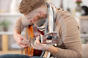 practicing in playing guitar handsome young men playing guitar photo