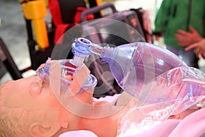 Practicing to use an oxygen mask on training doll