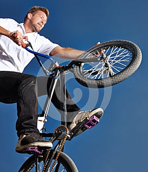 Practicing for the x games. Cropped shot of a teenage boy riding a BMX at a skatepark. photo