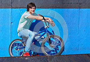 Practicing for the x games. Full length shot of a teenage boy riding a BMX at a skatepark. photo