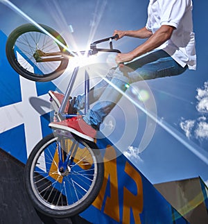 Practicing for the x games. a teenage boy riding a BMX at a skatepark. photo