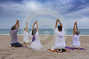 Practicing yoga on the beach