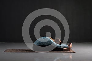 Practicing yoga, doing paschimottanasana exercise, Seated forward bend pose