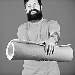 Practicing yoga every day. Man bearded athlete hold fitness mat. Fitness and stretching. Having good stretch. Athlete