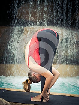 Practicing yoga. Padahastasana