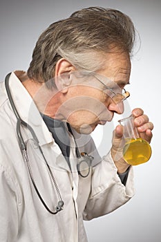 Practicioner in white gown determining disease with test tube of urine