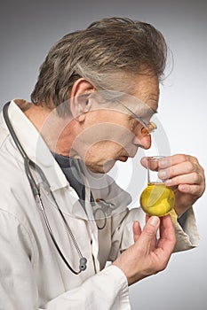 Practicioner in white gown determining disease with test tube of urine