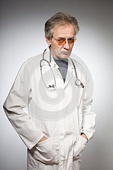 Practicioner in white gown posing in studio isolated on background