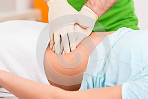 Practitioner at colon therapy massaging abdomen