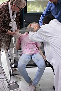 Practitioner doctor shining light into little girl patient eye while testing pupil reflexes during checkup visit