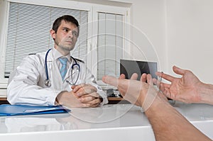 Practitioner doctor is talking with patient in office. Medical consultation or debate concept
