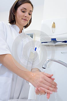 Practitioner washing her hands