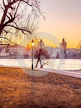 Prague bridge over a river with a city in the background