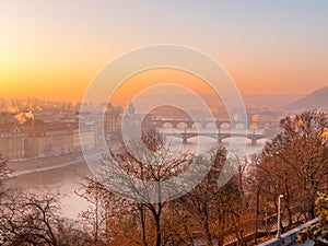 Prague bridge over a river with a city in the background