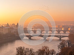 Prague bridge over a river with a city in the background