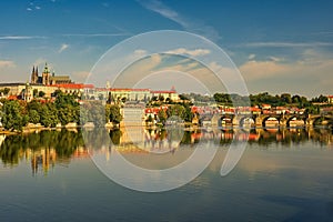 Prague, capital of the Czech Republic. Scenic sunset view of the Old Town pier architecture and Charles Bridge over Vltava river.