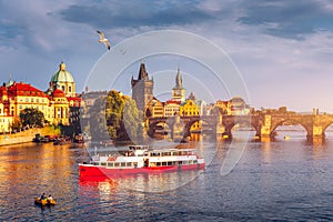 Prague Castle, Charles Bridge and boats on the Vltava river. View of Hradcany Prague Castle, Charles Bridge and a boats on the