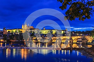 Prague Castle and the charles bridge with illumination during early evening