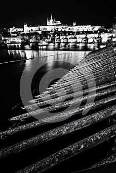 Prague castle and Charles bridge mirroring in Vltava river, colo