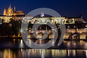 Prague Castle and Charles Bridge in night illumination, panoramic view of Prague.