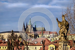 Prague castle and stone statue on Charles bridge, Czech republic