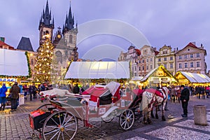 Prague Christmas market on the night in Old Town Square. Tyn Church, Bohemia. Blurred people on the move. Prague, Czech Republic.