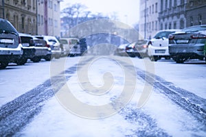 Prague city street under the snow. Cars driving on a blizzard road. Snow calamity in the city. Snow covered cars. Winter