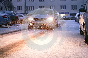 Prague city street under the snow. Cars driving on a blizzard road. Snow calamity in the city. Snow covered cars. Winter photo
