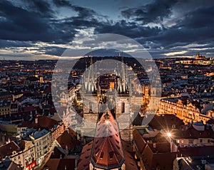 Prague, Czech Republic - Aerial drone view of the famous illuminated Church of our Lady Before Tyn with the Christmas market