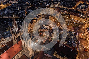 Prague, Czech Republic - Aerial drone view of the famous illuminated Church of our Lady Before Tyn towers at blue hour