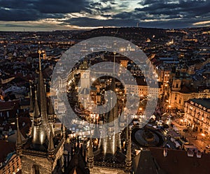 Prague, Czech Republic - Aerial drone view of the famous illuminated Church of our Lady Before Tyn towers at blue hour