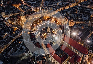 Prague, Czech Republic - Aerial drone view at night of the famous traditional Christmas market with illuminated Church