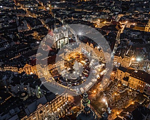 Prague, Czech Republic - Aerial view of the famous traditional Christmas market at Old Town Square at dusk with illuminated Church