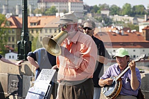 Prague, Czech Republic - April 19, 2011: Quartet of Musicians playing musical instruments for tourists on the street in Prague