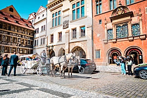 PRAGUE, CZECH REPUBLIC April 1, 2022: Wedding carriage with two horses on center of city at Old Town Square.