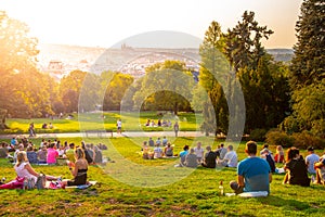 PRAGUE, CZECH REPUBLIC - AUGUST 17, 2018: Sunset in Rieger Gardens, Riegrovy sady, in Prague. Many people sitting in the